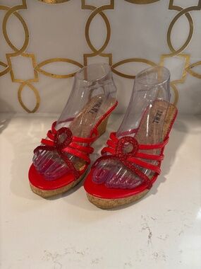 Women’s red wedge sandals with a braided strap design 8.5